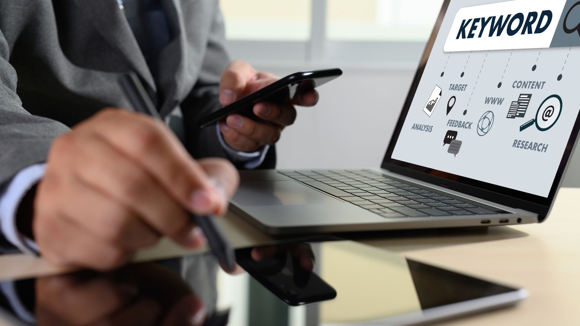A man holding his phone while doing a SEO keyword reasearch.