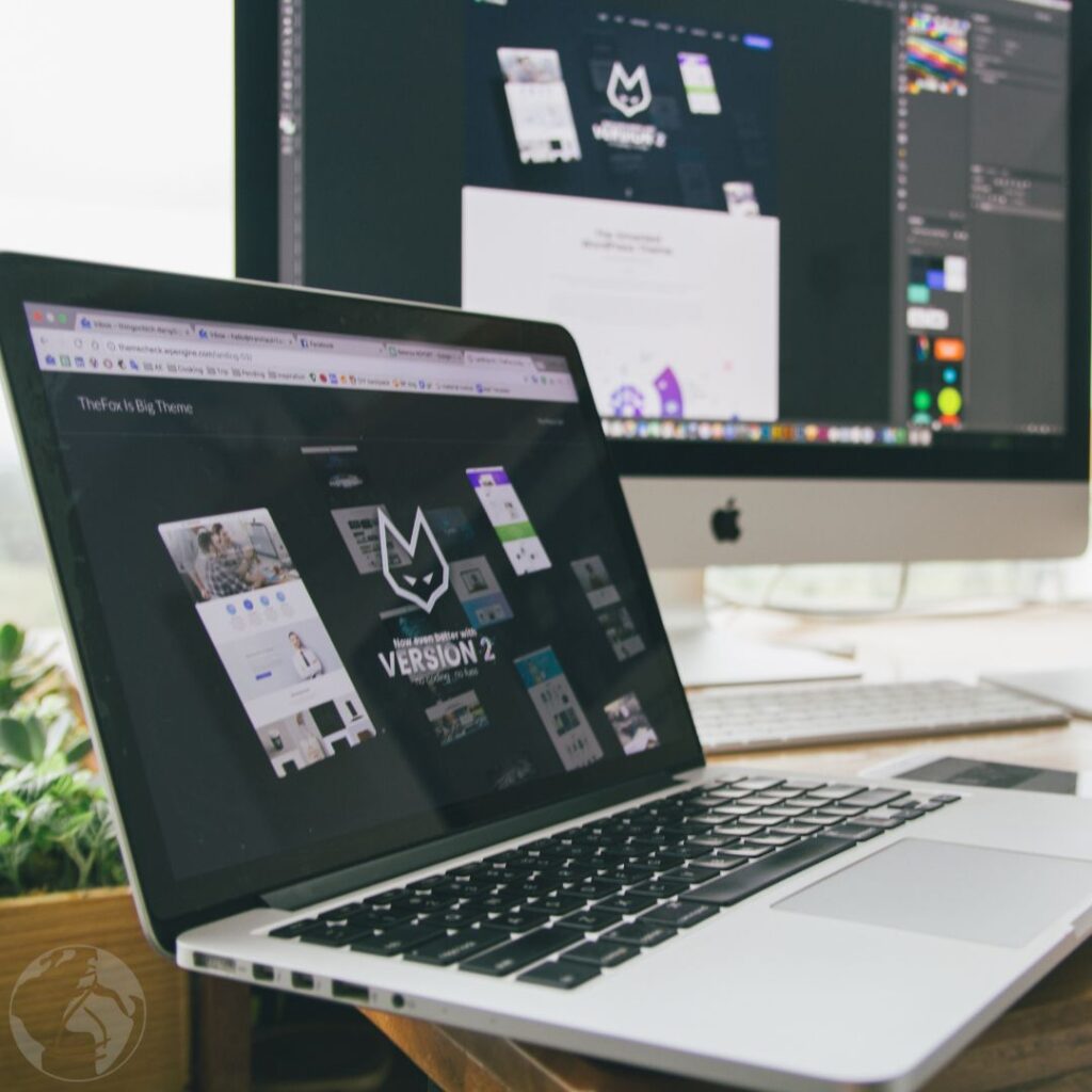 Macbook Pro Displaying Website Version 2 on Table