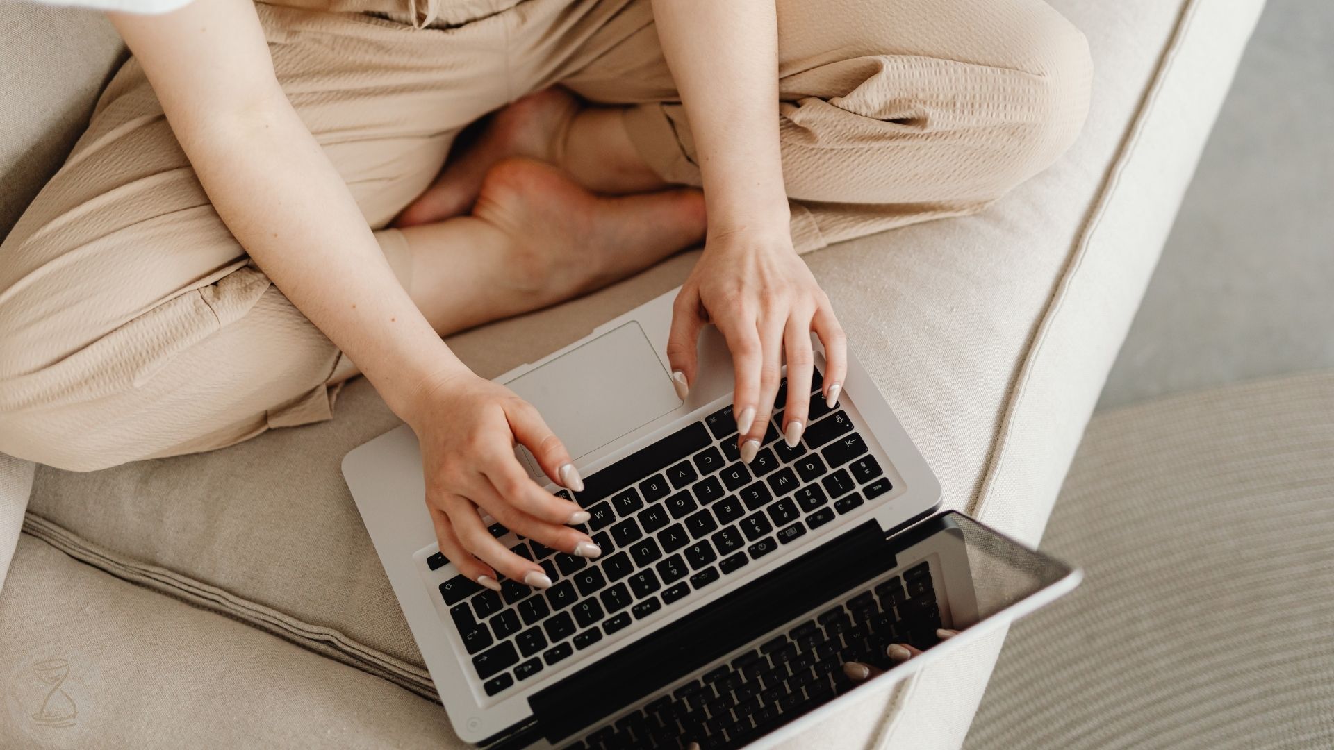 Overhead Shot of a Person's Hands Typing on a Silver Laptop