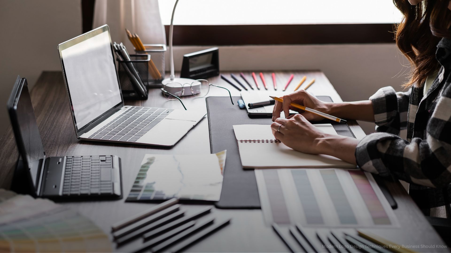 Graphic designer working with sketching logo design at office.